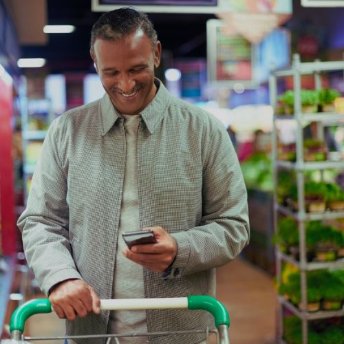 man using coupon and cashback apps to save on food