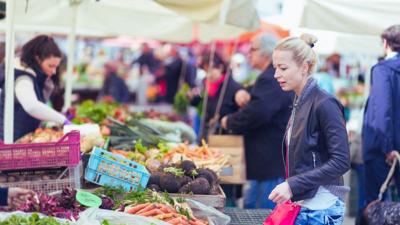 shopping at the local market to save money on food expenses